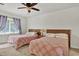Bedroom featuring two beds, a ceiling fan, and natural lighting at 802 Colony Pl. # 2E, Calabash, NC 28468
