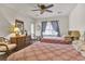 Comfortable bedroom with two beds, ceiling fan, and natural light at 802 Colony Pl. # 2E, Calabash, NC 28468