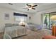 Inviting bedroom features two twin beds, neutral carpeting, and a ceiling fan at 802 Colony Pl. # 2E, Calabash, NC 28468