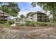 Exterior view of buildings nestled around a small pond featuring a fountain at 802 Colony Pl. # 2E, Calabash, NC 28468