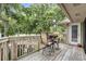 Comfortable deck with pond views, table and chairs, and access to the lush outdoors at 802 Colony Pl. # 2E, Calabash, NC 28468