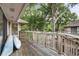 Spacious wooden deck with water views, kayaks, and wooded surroundings for outdoor living at 802 Colony Pl. # 2E, Calabash, NC 28468