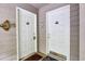 Condo building entrance with two white doors, seahorse and fish decorations, and welcome mats at 802 Colony Pl. # 2E, Calabash, NC 28468