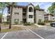 Exterior view of The Colony Building 2 with neutral siding, balconies, and well maintained landscaping at 802 Colony Pl. # 2E, Calabash, NC 28468