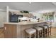 Kitchen featuring a breakfast bar with barstool seating, black appliances, and ample storage at 802 Colony Pl. # 2E, Calabash, NC 28468
