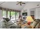 Inviting living room featuring a large sliding glass door, ceiling fan, and modern decor at 802 Colony Pl. # 2E, Calabash, NC 28468