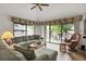 Comfortable living room with sliding glass doors to a patio and ceiling fan at 802 Colony Pl. # 2E, Calabash, NC 28468