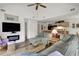 Open-concept living room next to kitchen featuring a vaulted ceiling, fireplace, and comfortable seating at 802 Colony Pl. # 2E, Calabash, NC 28468