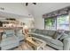 Spacious living room featuring an open layout with the kitchen and sliding glass doors to the balcony at 802 Colony Pl. # 2E, Calabash, NC 28468