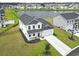 Aerial view of white two-story home with lake view and green backyard at 863 Agostino Dr., Myrtle Beach, SC 29579