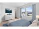 The primary bedroom features modern decor, wood-look floors and a large window offering lots of natural light at 863 Agostino Dr., Myrtle Beach, SC 29579