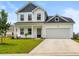 Charming two-story home with a well-manicured lawn, attached garage, and a welcoming front porch at 863 Agostino Dr., Myrtle Beach, SC 29579