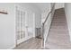 Spacious hallway with hardwood floors, a staircase, and glass doors leading to another room at 863 Agostino Dr., Myrtle Beach, SC 29579