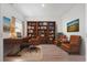 Elegant home office with a wooden desk, leather chairs, and a full bookcase at 863 Agostino Dr., Myrtle Beach, SC 29579
