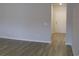 Hallway featuring neutral paint, light-colored flooring, and a white door at 8715 Baton Rouge Ave Nw, Calabash, NC 28467