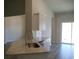 The kitchen features a granite countertop, a stainless steel sink, and a sliding glass door at 8715 Baton Rouge Ave Nw, Calabash, NC 28467