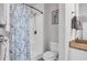 Bright bathroom featuring a shower with blue floral curtain, toilet, and vanity with a tan countertop at 959 Hendrick Ave. # 0, Myrtle Beach, SC 29577
