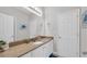 Bathroom showcasing single sink vanity with granite counters, white cabinets, a large mirror, and neutral paint at 959 Hendrick Ave. # 0, Myrtle Beach, SC 29577