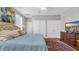 Cozy bedroom with a plush bed, patterned rug, and classic wooden dresser beneath a flat screen television at 959 Hendrick Ave. # 0, Myrtle Beach, SC 29577