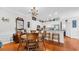 Charming dining room open to the kitchen, with hardwood floors and white cabinets at 959 Hendrick Ave. # 0, Myrtle Beach, SC 29577