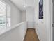 Well-lit hallway with neutral carpet, white walls, and shuttered windows, leading to more rooms at 959 Hendrick Ave. # 0, Myrtle Beach, SC 29577