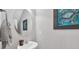 Charming powder room with a pedestal sink, decorative mirror, and unique crab artwork at 959 Hendrick Ave. # 0, Myrtle Beach, SC 29577