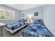 Bedroom with two beds, blue accents and decor, and a bright window at 9661 Shore Dr. # A1, Myrtle Beach, SC 29572