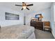 Comfortable bedroom featuring a ceiling fan, soft lighting, and a dresser with ample storage at 9661 Shore Dr. # A1, Myrtle Beach, SC 29572