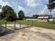 Spacious backyard featuring a chain-link fence, a concrete patio, and a brick storage shed at 1002 S Beech Ave., Andrews, SC 29510