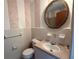 Retro bathroom with pink tile, a round mirror, and vintage fixtures at 1002 S Beech Ave., Andrews, SC 29510