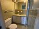 Retro bathroom featuring classic tile work, toilet, walk-in shower, and traditional vanity with sink and mirror at 1002 S Beech Ave., Andrews, SC 29510