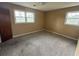 Standard bedroom with carpet, two windows providing natural light, and neutral wall color at 1002 S Beech Ave., Andrews, SC 29510