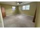 This bedroom boasts carpet, a ceiling fan, and two windows for natural light, providing a cozy atmosphere at 1002 S Beech Ave., Andrews, SC 29510