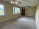 Spacious living room featuring carpet flooring and two ceiling fans at 1002 S Beech Ave., Andrews, SC 29510