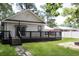 Charming backyard features a deck, spacious green lawn, and easy access to the home at 1014 Bay Dr., Surfside Beach, SC 29575