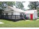 This home includes a backyard with a deck and bonus room with a red door at 1014 Bay Dr., Surfside Beach, SC 29575