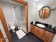 Bathroom featuring a glass enclosed shower, wood-framed mirror, and a toilet at 1014 Bay Dr., Surfside Beach, SC 29575
