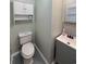 A well-lit bathroom with a modern toilet and stylish vanity with tile flooring at 1014 Bay Dr., Surfside Beach, SC 29575