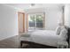 A well lit bedroom with a sliding glass door out to a deck and wood-look flooring at 1014 Bay Dr., Surfside Beach, SC 29575