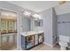Bathroom shows a double vanity, open storage, toilet and partial view to living room at 1033 Mccall Loop, Conway, SC 29526