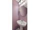 Cozy half bathroom featuring a pedestal sink and light purple walls at 1033 Mccall Loop, Conway, SC 29526