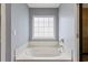 Bright bathroom showcasing a soaking tub beneath a window for a relaxing bathing experience at 1033 Mccall Loop, Conway, SC 29526