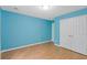 Bedroom with hardwood floors and a double door closet offering ample storage space at 1033 Mccall Loop, Conway, SC 29526