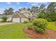 A charming two-story home with a well-maintained lawn and landscaping, nestled in a serene neighborhood setting at 1033 Mccall Loop, Conway, SC 29526