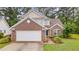 Inviting two-story home with brick and siding exterior, featuring a well-maintained lawn and a spacious two-car garage at 1033 Mccall Loop, Conway, SC 29526