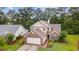 Charming two-story home featuring brick and siding accents, complemented by a lush green lawn and mature trees at 1033 Mccall Loop, Conway, SC 29526