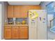 Kitchen features wood cabinets, light countertop, and stainless steel refrigerator near the stairs at 1033 Mccall Loop, Conway, SC 29526