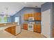 Kitchen featuring wood cabinets, a peninsula, and white appliances; view to breakfast area at 1033 Mccall Loop, Conway, SC 29526