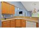 Open kitchen with wood cabinets and countertops, a white sink, and view to living area at 1033 Mccall Loop, Conway, SC 29526