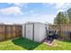 Backyard shed for extra storage with a wood fence and a small amount of grass at 104 Clovis Circle, Myrtle Beach, SC 29579